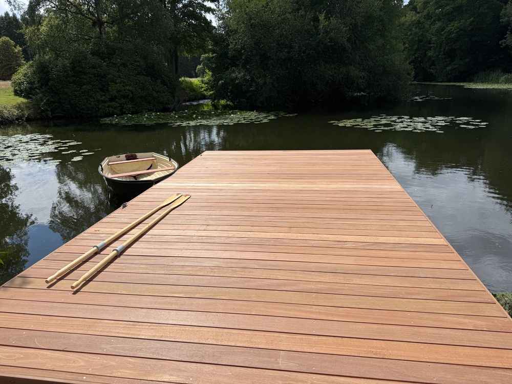 Smooth Yellow Balau timber decking with mooring cleats installed on bespoke aluminum-framed jetty for a private property pond.